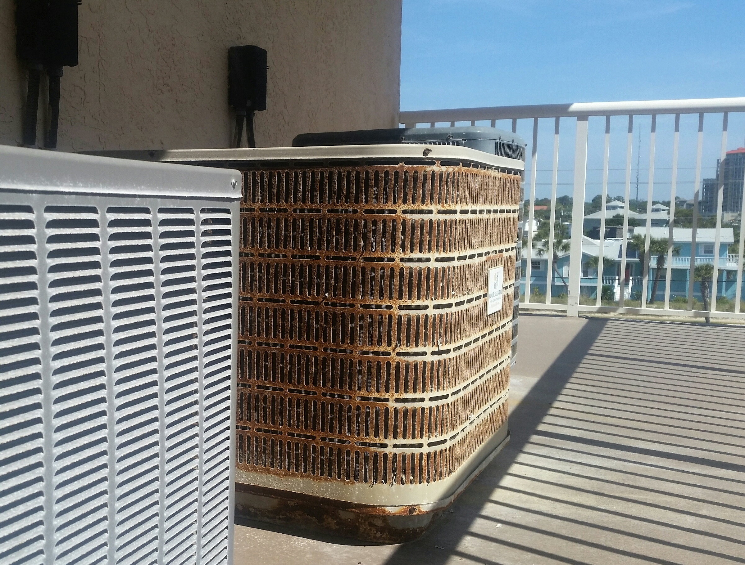 Weathered AC system showing age and rust, example of system needing replacement